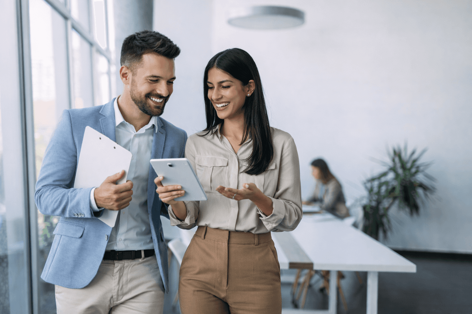 Two professionals reviewing Uxify partner dashboard